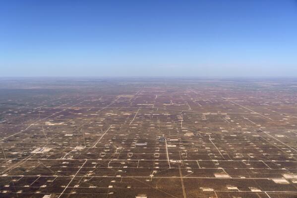 Patches of land housing oil pumpjacks dot the landscape of the Permian Basin in Midland, Texas, Monday, Oct. 11, 2021. Carbon Mapper, a partnership of university researchers and NASA’s Jet Propulsion Laboratory, documented massive amounts of methane venting into the atmosphere from oil and gas operations across the Permian, a 250-mile-wide bone-dry expanse along the Texas-New Mexico border that a billion years ago was the bottom of a shallow sea. (AP Photo/David Goldman)