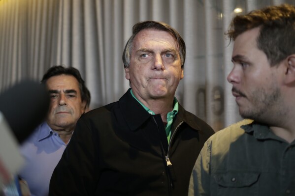 FILE - Brazil's former President Jair Bolsonaro prepares to speak to the press at a restaurant in Belo Horizonte, Brazil, June 30, 2023, the day that judges ruled him ineligible to run for any political office again until 2030 after concluding that he abused his power and cast unfounded doubts on the country's electronic voting system. (AP Photo/Thomas Santos, File)