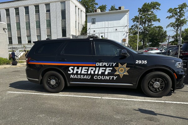 A Nassau County Deputy Sheriff's vehicle sits parked outside the Nassau Family Court, Tuesday, June 4, 2024, in Westbury, N.Y. Nassau County which has one of the nation's largest police forces, is training a unit of armed residents that can be called up during natural disasters and other major emergencies. But some residents of Nassau County in the New York City suburbs say the so-called "provisional special deputy sheriffs" are a dangerous example of fear mongering and government overreach. (AP Photo/Phil Marcelo)