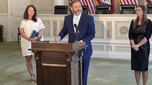 Cody Hiland speaks at the old state Supreme Court chamber at the Arkansas Capitol in Little Rock, Ark., Monday, July 3, 2023, after Gov. Sarah Huckabee Sanders, right, announced his appointment to the Supreme Court. Hiland will fill the vacancy of Justice Robin Wynne, who died in June. (AP Photo/Andrew DeMillo)