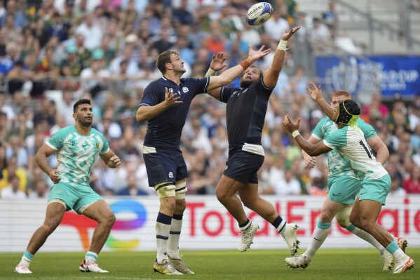 Scotland's Richie Gray, center left, and his teammate Pierre Schoeman, try to catch the ball during the Rugby World Cup Pool B match between South Africa and Scotland at the Stade de Marseille in Marseille, France, Sunday, Sept. 10, 2023. (AP Photo/Pavel Golovkin)