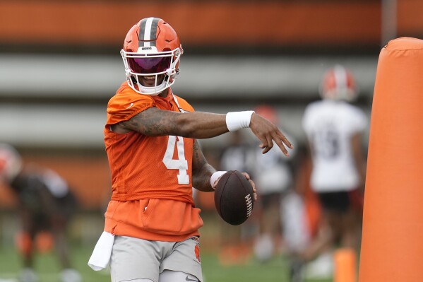 Cleveland Browns quarterback Deshaun Watson simulates throwing a pass during NFL football practice in Berea, Ohio, Wednesday, May 22, 2024. He took part in most of the drills on the second day of organized team activities (OTAs) but didn't do any passing. (AP Photo/Sue Ogrocki)