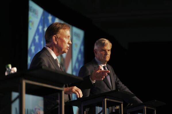 In this photo provided by WTNH-TV, Democratic Connecticut Gov. Ned Lamont, left, speaks during a gubernatorial debate as Republican Bob Stefanowski listens in background, in Uncasville, Conn., Tuesday, Nov. 1, 2022. (Anthony Quinn/WTNH-TV via AP)