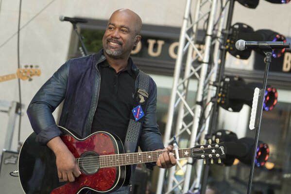 FILE - In this May 25, 2018 file photo, Darius Rucker performs on NBC's Today show at Rockefeller Plaza in New York.  The Country singer couldn’t quite believe it when he was surprised this week with the news that his song “Wagon Wheel” was certified eight times platinum, making it one of the top five most popular country singles ever.   On Wednesday, Feb. 12, 2020, Rucker stopped by the Country Music Hall of Fame and Museum to his items in an exhibit, but his label, Universal Music Group Nashville, surprised him with a plaque featuring eight platinum-colored records.  (Photo by Charles Sykes/Invision/AP, File)