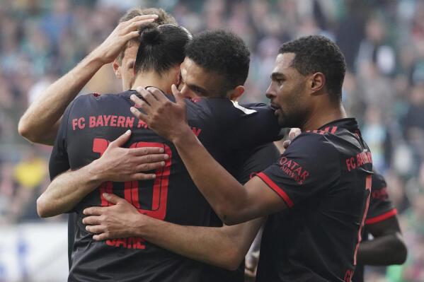 Bayern's goal scorer Leroy Sane, left,celebrates with Bayern's Serge Gnabry, right, and Bayern's Noussair Mazraoui during a German Bundesliga soccer match between Werder Bremen and Bayern Munich in Bremen, Germany, Saturday, May 6, 2023. (Marcus Brandt/dpa via AP)