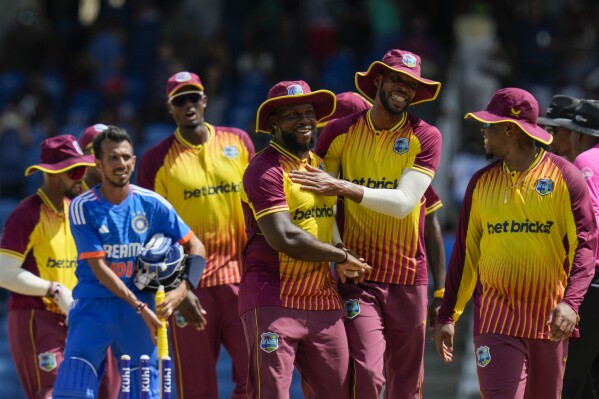 West Indies' Roston Chase, right, and Kyle Mayers embrace after defeating India for 4 runs in their first T20 cricket match at the Brian Lara Stadium in Tarouba, Trinidad and Tobago, Thursday, Aug. 3, 2023. (AP Photo/Ramon Espinosa)