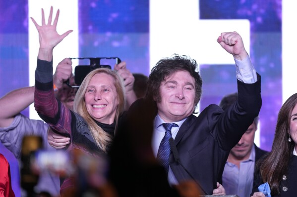 Javier Milei, presidential candidate of the Liberty Advances coalition, embraces his sister Karina at his campaign headquarters after polling stations closed during primary elections in Buenos Aires, Argentina, Sunday, Aug. 13, 2023. (AP Photo/Natacha Pisarenko)