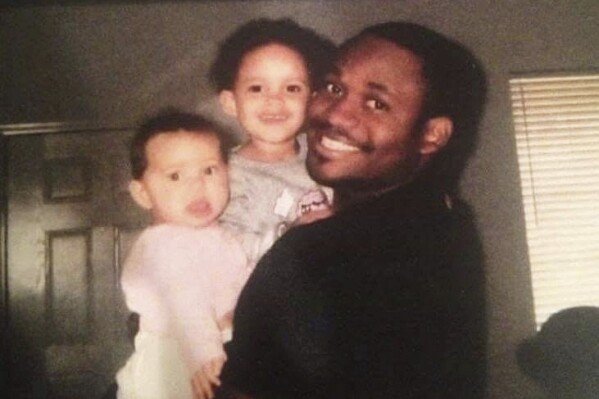 This 2008 photo provided by Lisa Afolayan shows Nate Afolayan with his daughters, Natalee and Lea, at their home in San Jacinto, Calif. (Lisa Afolayan via AP)