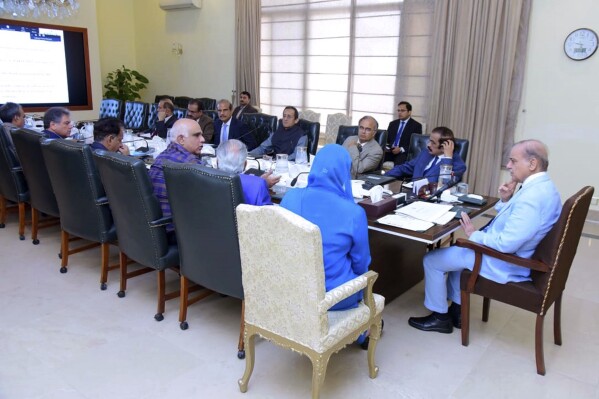 FILE - In this photo released by Press Information Department, Prime Minister Prime Minister Shahbaz Sharif, right, chairs a meeting regarding ongoing crackdown against human smugglers, in Islamabad, Pakistan on June 21, 2023. The government has also launched a crackdown on the human traffickers who arranged travel for the Pakistanis on the fishing boat, many of whom were seeking jobs in Europe. So far, police have arrested at least 17 suspected traffickers in connection with the case.(Press Information Department via AP, File)