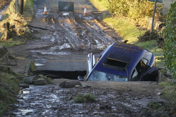 A car on a bridge washed away following torrential rain, near Dundee, Scotland, Saturday, Oct. 21, 2023. A storm battered Britain, northern Germany and southern Scandinavia for a third day with powerful winds, heavy rain and storm surges that caused floods, power outages, evacuations, and traffic disruptions. (Andrew Milligan/PA via AP)