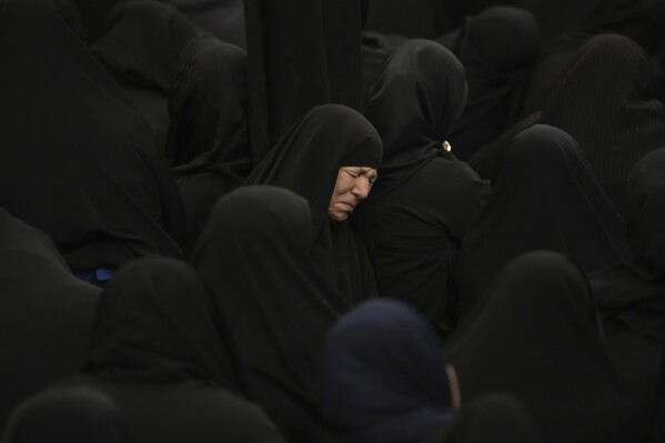 A women weeps during the Ashoura mourning ritual, Friday, July 28, 2023, in Tehran, Iran. Millions of Shiite Muslims around the world on Friday commemorated Ashoura, a remembrance of the 7th-century martyrdom of the Prophet Muhammad's grandson, Hussein, that gave birth to their faith. (AP Photo/Vahid Salemi)