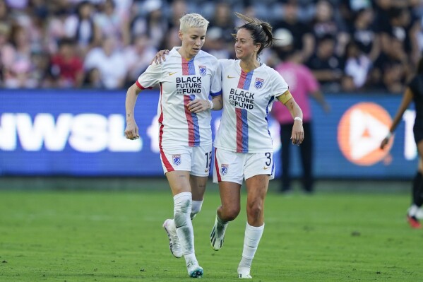 OL Reign forward Megan Rapinoe (15) celebrates her goal by penalty kick with defender Lauren Barnes (3) during the second half of an NWSL soccer match against Angel City FC, Sunday, Aug. 27, 2023, in Los Angeles. (AP Photo/Ryan Sun)