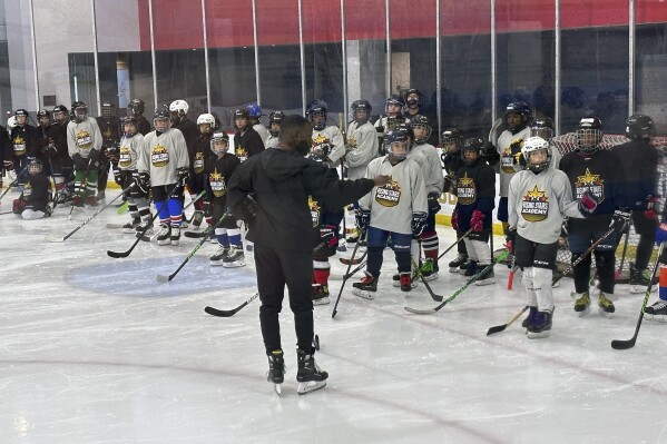 Duante' Abercrombie speaks to players as an instructor at the Washington Capitals' inaugural Rising Stars Academy at Medstar Capitals Iceplex in Arlington, Virginia, Sunday, Aug. 20, 2023. The Rising Stars Academy that took place Aug. 19-20 was designed to provide minority hockey players with elite on-ice skill development and off-ice training geared toward problem-solving and handling some racist elements of the sport that remains predominantly white (AP Photo/Stephen Whyno)