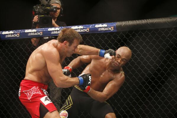 FILE - Anderson Silva, right, of Brazil, fights Stephan Bonnar, of the United States, during their light heavyweight mixed martial arts bout at the Ultimate Fighting Championship (UFC) 153 in Rio de Janeiro, Oct. 14, 2012. UFC says former fighter Bonnar, who played a significant role in the UFC’s growth into the dominant promotion in mixed martial arts, has died. The UFC Hall of Famer was 45. UFC announced in a statement that Bonnar died Thursday, Dec. 22, 2022, from “presumed heart complications while at work.” (AP Photo/Felipe Dana, File)