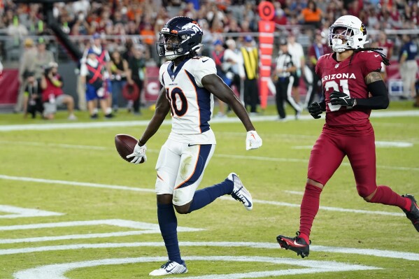 Denver Broncos wide receiver Jerry Jeudy, left, scores in front of Arizona Cardinals safety Andre Chachere (31) during the first half of an NFL preseason football game in Glendale, Ariz., Friday, Aug. 11, 2023. (AP Photo/Ross D. Franklin)