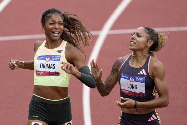 Gabby Thomas celebrates after winning the women's 200-meter final with third place winner McKenzie Long during the U.S. Track and Field Olympic Team Trials Saturday, June 29, 2024, in Eugene, Ore. (AP Photo/Chris Carlson)