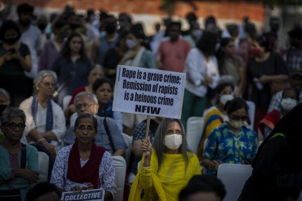A woman holds a placard during a protest against remission of sentence by the government to convicts of a gang rape of a Muslim woman, in New Delhi, India, Saturday, Aug. 27, 2022. The victim, who is now in her 40s, was pregnant when she was brutally gang raped in communal violence in 2002 in the western state of Gujarat, which saw over 1,000 people, mostly Muslims, killed in some of the worst religious riots India has experienced since its independence from Britain in 1947.  (AP Photo/Altaf Qadri)