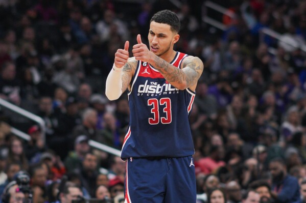 FILE - Washington Wizards forward Kyle Kuzma gestures to teammates during the second half of an NBA basketball game against the Sacramento Kings on March 18, 2023, in Washington. Kuzma will be a free agent when the league's annual offseason shopping period starts next week. Kuzma has declined his $13 million player option with the Wizards for next season, a person with knowledge of his decision said Tuesday, June 20, 2023, meaning he will be a free agent. The person spoke to The Associated Press on condition of anonymity because neither side disclosed the move. (AP Photo/Jess Rapfogel, File)