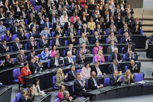 Leader of the Christian Democrats Friedrich Merz, third from right, listens to a debate iahead of a second round of vote at the German federal parliament, Bundestag, at the Reichstag building in Berlin, Germany, Tuesday, May 6, 2025. (AP Photo/Markus Schreiber)