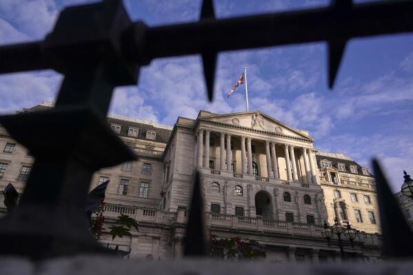The Bank of England stands in the financial district of The City of London, Wednesday, Oct. 12, 2022. The pound sank against the dollar early Wednesday after the Bank of England governor confirmed the bank won't extend an emergency debt-buying plan introduced last month to stabilize financial markets.(AP Photo/Alberto Pezzali)
