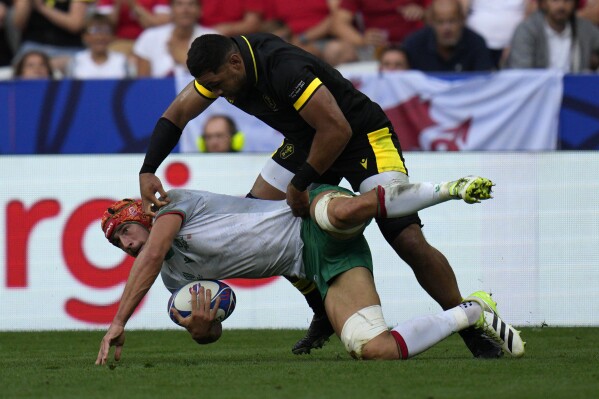 Wales' Taulupe Faletau stops Portugal's Nicolas Martins during the Rugby World Cup Pool C match between Wales and Portugal at the Stade de Nice, Saturday, Sept. 16, 2023 in Nice, southern France. (AP Photo/Daniel Cole)