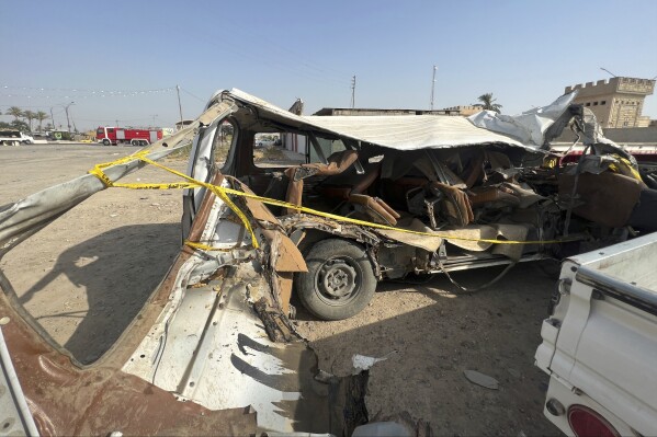 The bus that crashed today while carrying pilgrims to Karbala is pictured at the police station in Balad, Iraq, Saturday Sept. 2, 2023. A bus carrying pilgrims to the Iraqi city of Karbala overturned north of Baghdad on Saturday, killing 18 people, medical officials said. (AP Photo/Ali Jabar)
