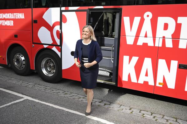 Swedish Prime Minister Magdalena Andersson disembarks the Social Democrats bus in the city of Norrtalje, Sweden, Sunday Sept. 4, 2022.  Andersson is on the campaign trail a week before the national election. She traveled by bus Sunday to communities near Stockholm seeking to win over voters concerned over gang violence and electricity bills that have risen painfully since Russia invaded Ukraine. (Jessica Gow/TT News Agency via AP)
