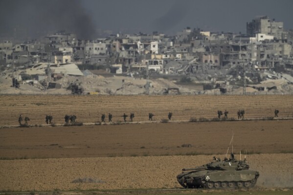 Israeli troops are seen near the Gaza Strip border, in southern Israel on Sunday, Dec. 10, 2023. (AP Photo/Leo Correa)