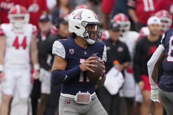 FILE - Arizona quarterback Noah Fifita (11) in the second half during an NCAA college football game against Utah, Saturday, Nov. 18, 2023, in Tucson, Ariz. Arizona can make a lasting impression before leaving the Pac-12 to join the Big 12 next season.The Wildcats — two seasons removed from winning one game — face traditional power Oklahoma in the Alamo Bowl. (AP Photo/Rick Scuteri, File)