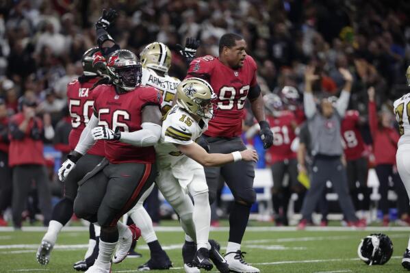New Orleans Saints quarterback Trevor Siemian (15) is hit after throwing in the first half of an NFL football game against the Tampa Bay Buccaneers in New Orleans, Sunday, Oct. 31, 2021. (AP Photo/Derick Hingle)