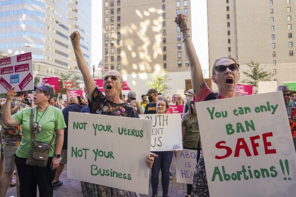 FILE - Adrienne Daily, center, and her daughter, Kierson Daily, raise their fists in protests during a rally against the U.S. Supreme Court's decision to overturn Roe v. Wade, June 24, 2022, in Pittsburgh. Democrats in Pennsylvania will try to resurrect the voter energy behind protecting abortion rights that helped them win critical openings for governor and U.S. Senate in 2022 as they try to now protect their state Supreme Court majority in the presidential battleground. (Steve Mellon/Pittsburgh Post-Gazette via AP, File)