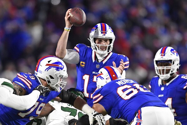 Buffalo Bills quarterback Josh Allen, center, looks to pass during the first half of an NFL football game against the New York Jets in Orchard Park, N.Y., Sunday, Nov. 19, 2023. (AP Photo/Adrian Kraus)