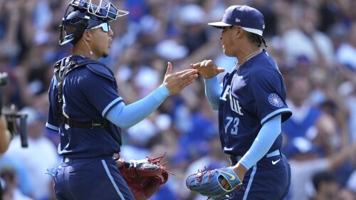 Chicago Cubs relief pitcher Adbert Alzolay, right, and catcher Miguel Amaya, left, celebrate after a win over the St. Louis Cardinals in a baseball game Friday, July 21, 2023, in Chicago. (AP Photo/Charles Rex Arbogast)