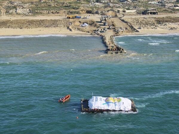 In this photo provided by the Israeli military, humanitarian aid transported from a ship belonging to the World Central Kitchen (WCK), led by the United Arab Emirates, arrives in the maritime space of the Gaza Strip, Friday, March 15, 2024. (Israel Defense Forces) via AP)