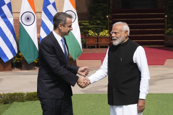 Greece's Prime Minister Kyriakos Mitsotakis, left, talks with his Indian counterpart Narendra Modi as he arrives for a delegation level meeting in New Delhi, India, Wednesday, Feb. 21, 2024. (AP Photo/Manish Swarup)