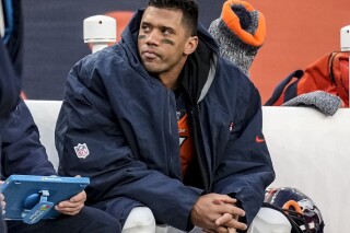 FILE - Denver Broncos quarterback Russell Wilson sits on the bench during the second half of an NFL football game against the Los Angeles Chargers, Sunday, Dec. 31, 2023, in Denver. Wilson has agreed to sign a one-year deal with the Pittsburgh Steelers, a person familiar with the details told The Associated Press on Sunday night, March 10, 2024. (AP Photo/David Zalubowski, File)