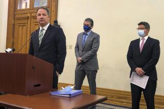 Indiana House Speaker Todd Huston, R-Fishers, speaks during a news conference at the Indiana Statehouse in Indianapolis, Thursday, April 15, 2021, with Indiana Senate Appropriations Committee Chairman Ryan Mishler, R-Bremen, center, and Senate President Pro Tem Rodric Bray, R-Martinsville. A new state revenue report given Thursday to legislators projects tax collections will bounce back stronger than expected from the pandemic recession. (AP Photo/Tom Davies)