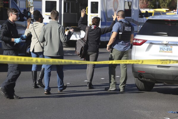 Police work at the scene of a fatal shooting that killed several people on the campus of the University of Nevada, Las Vegas, Wednesday, Dec. 6, 2023, in Las Vegas.  The attack, shortly before noon, prompted police to swarm the campus, which is just a couple of miles from the world-famous Las Vegas Strip, as students barricaded themselves in classrooms.  (Kevin Cannon/Las Vegas Review-Journal via AP)
