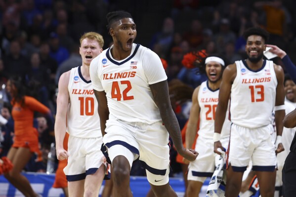 Illinois forward Dain Dainja (42) celebrates after a dunk against Morehead State in the second half of a first-round college basketball game in the NCAA Tournament, Thursday, March 21, 2024, in Omaha, Neb. (AP Photo/John Peterson)