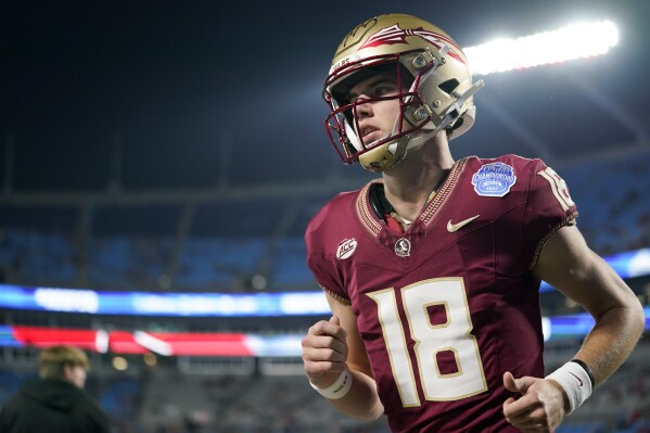 Florida State quarterback Tate Rodemaker runs to the field before the team's Atlantic Coast Conference Championship NCAA college football game against Louisville, Saturday, Dec. 2, 2023, in Charlotte, N.C. (AP Photo/Erik Verduzco)