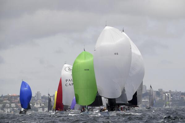 Yachts use their spinnakers at the start of the 76th annual Sydney Hobart yacht race in Sydney, Sunday, Dec. 26, 2021. Last year's race was canceled the week before it was due to start because of coronavirus-related quarantine issues, but the 2021 edition is proceeding with mass virus-testing protocols in place. (Dan Himbrechts/AAP Image via AP)