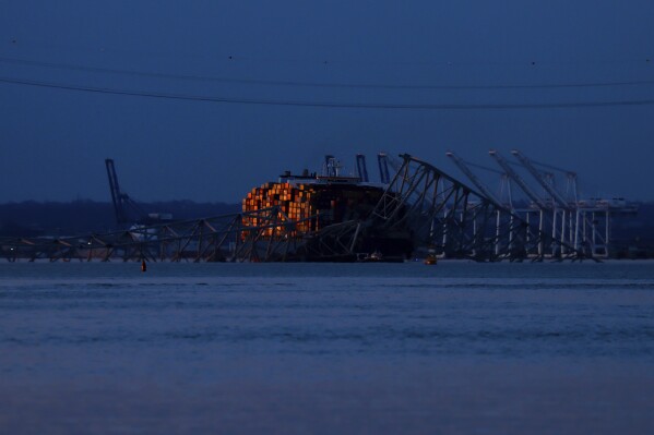 Wreckage of the Francis Scott Key Bridge rests on the container ship Dali, Sunday, March 31, 2024, in Baltimore. (AP Photo/Julia Nikhinson)
