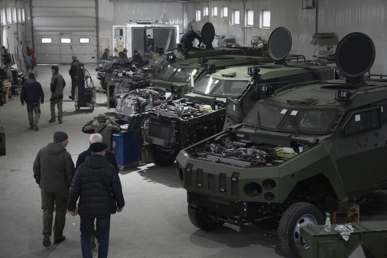 Armored vehicles are worked on at a factory in Ukraine, on Friday, December 22, 2023. (AP Photo/Evgeniy Maloletka)