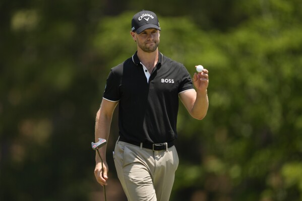 Thomas Detry, of Belgium, waves after making a putt on the fifth hole during the second round of the U.S. Open golf tournament Friday, June 14, 2024, in Pinehurst, N.C. (AP Photo/Matt York)