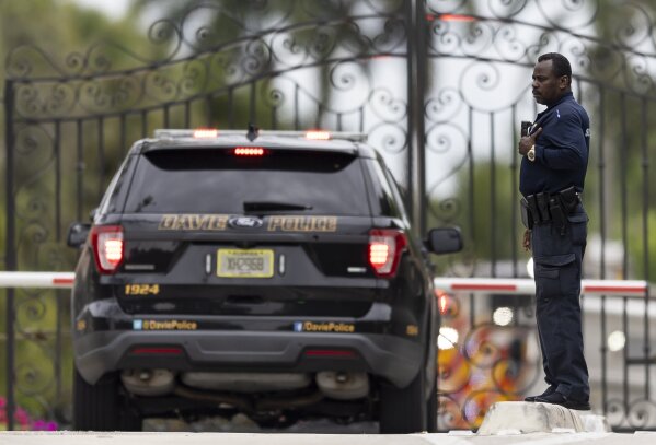 A security guard looks on as first responders make their way into the Landmark Ranch Estates neighborhood on Wednesday, Jan. 3, 2024, in Southwest Ranches, Fla. Fire rescue crews alongside the Broward Sheriff's Office worked to put out a two-alarm fire at a home belonging to Miami Dolphins wide receiver Tyreek Hill inside the private neighborhood. (Matias J. Ocner/Miami Herald via AP)