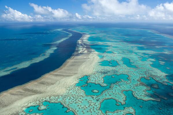 FILE - In this undated photo provided by the Great Barrier Reef Marine Park Authority, the Great Barrier Reef near the Whitsunday, Australia, region is viewed from the air. A United Nations-backed mission is recommending that the Great Barrier Reef be added to the list of endangered World Heritage sites, sounding the alarm that without "ambitious, rapid and sustained" climate action the world's largest coral reef is in peril. The warning came in a report published Monday Nov. 28, 2022 following a 10-day mission to the reef last March by officials from UNESCO and the International Union for Conservation of Nature.(Jumbo Aerial Photography/Great Barrier Reef Marine Park Authority via AP)