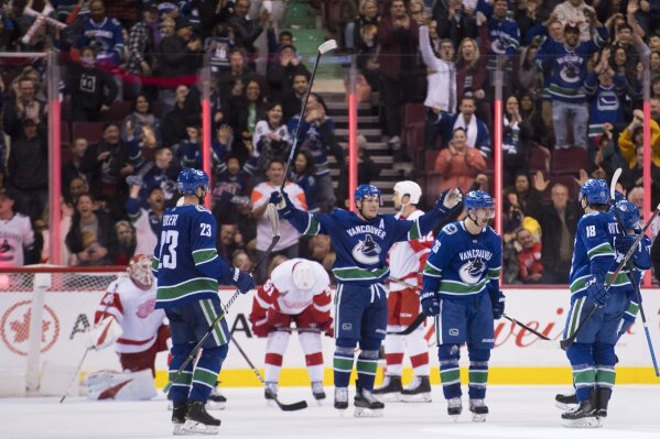
              Vancouver Canucks left wing Antoine Roussel (26) celebrates his goal against the Detroit Red Wings during third-period NHL hockey game action in Vancouver, British Columbia, Sunday, Jan 20, 2019. (Jonathan Hayward/The Canadian Press via AP)
            