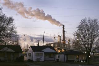In an undated file photo, smoke billows from a Marathon Petroleum refinery near a neighborhood in southwest Detroit. One year after launching its Climate Funders Justice Pledge, The Donors of Color Network says it now has a $100 million funding baseline for environmental groups led by the minorities already disproportionately harmed by extreme weather events. The network also plans to announce Tuesday, April 5, 2022 that ClimateWorks Foundation will sign the full pledge, promising transparent reporting of their grants and to direct at least 30% of its climate funding grants to groups with Black, Indigenous or other people of color as their leaders. (Romain Blanquart/Detroit Free Press via AP)