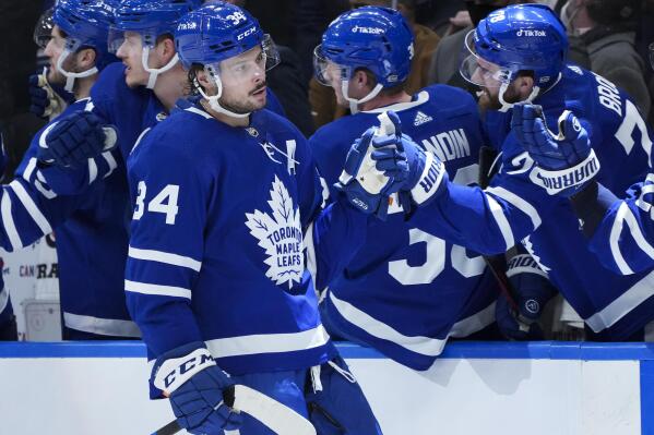Toronto Maple Leafs forward Auston Matthews is congratulated after his second goal of the night against the Minnesota Wild, during the third period of an NHL hockey game Thursday, Feb. 24, 2022, in Toronto. (Nathan Denette/The Canadian Press via AP)