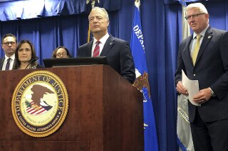 Nicola T. Hanna, U.S. Attorney for the Central District of California, at podium, announces at a news conference in Los Angeles Friday, Feb. 21, 2020, that Wells Fargo has agreed to pay $3 billion to settle criminal and civil investigations into a long-running practice whereby company employees opened millions of unauthorized bank accounts in order to meet unrealistic sales goals. (AP Photo/Stefanie Dazio)